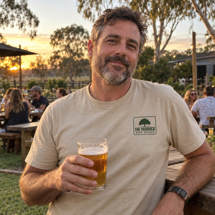The owner at a garden table in the pub tee