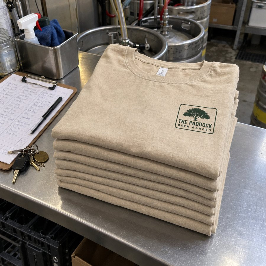 Pub tees folded on the bar bench, logo on the chest